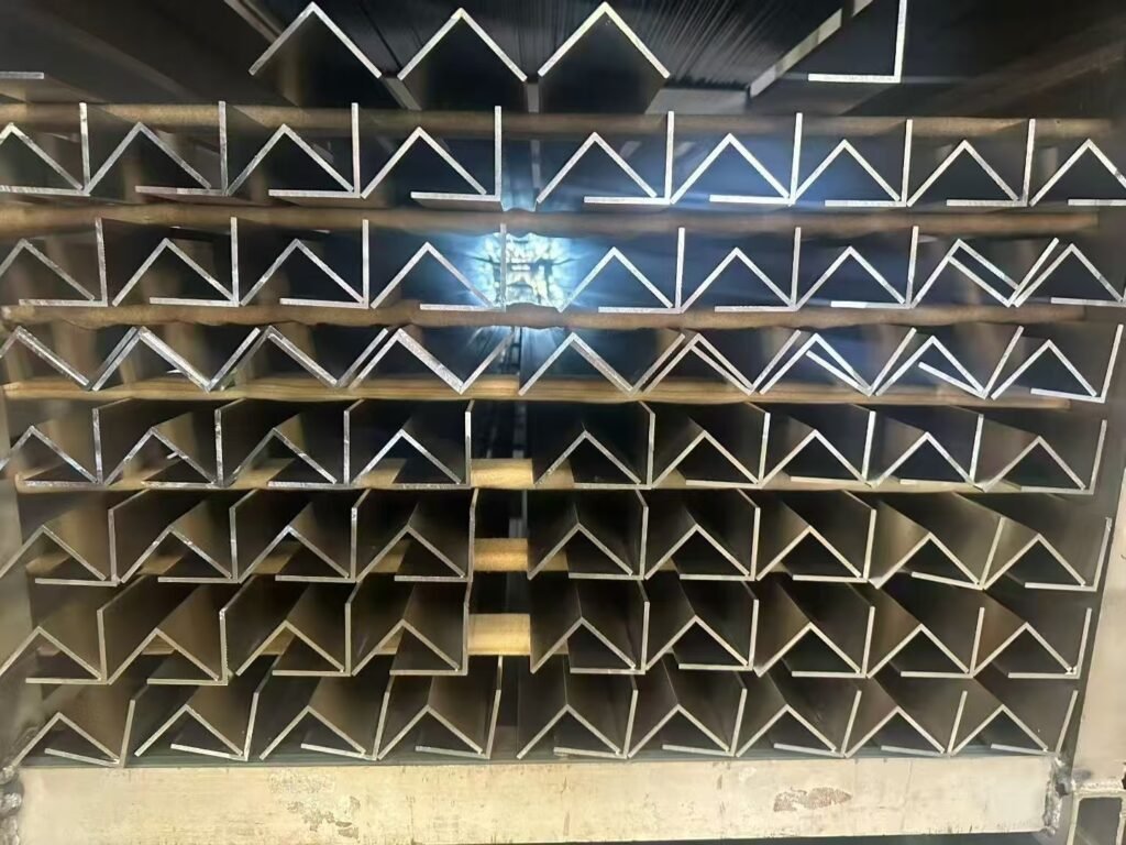 Close-up of various complex-shaped aluminum profile cross-sections, showcasing custom production capability